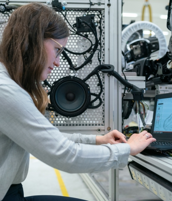 Female software engineer inspecting server hardware with guidance from an engineer home loan broker sydney